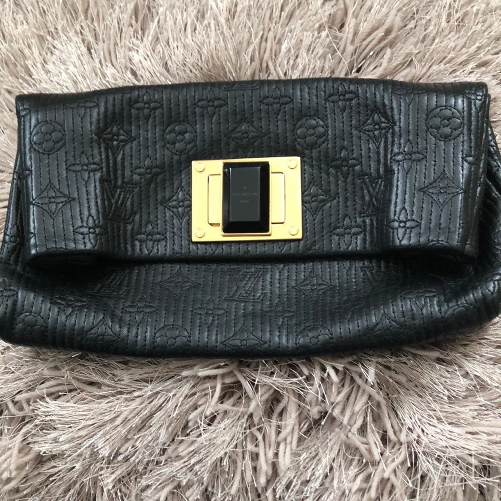 LV Montaigne leather clutch with gold hardware.